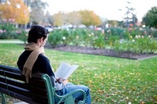Person reading on a bench in the Benalla Botanical Gardens